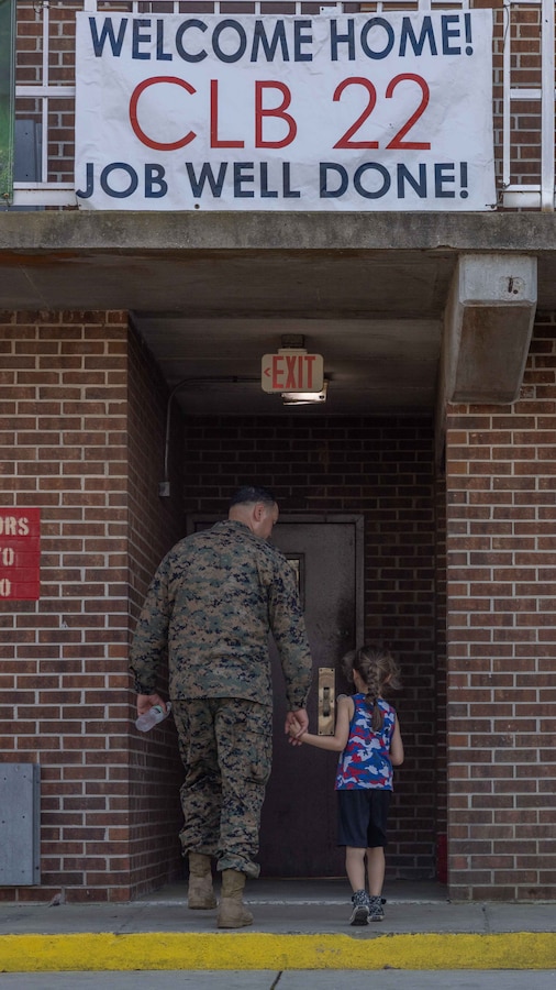 U.S. Marines with Combat Logistics Battalion 22, 26th Marine Expeditionary Unit (Special Operations Capable) (MEU(SOC)) reunites with his family, Camp Lejeune, North Carolina, Mar. 18, 2024. The 26th MEU(SOC) returned home after completing a eight-month deployment embarked aboard the Bataan Amphibious Ready Group (BAT ARG). During its deployment, the BAT ARG and 26th MEU(SOC) team participated in a wide array of exercises with NATO Allies and regional partners spanning across the Tri-Geographic Combatant Command to enhance interoperability, MAGTF readiness, and provide crisis response options. (U.S. Marine Corps photo by Cpl. Jackson Kirkiewicz)