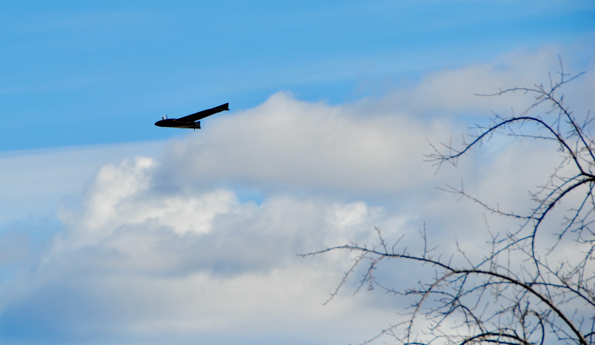 A black small unmanned aerial system drone flies over Westover Air Reserve Base on Marc h19.