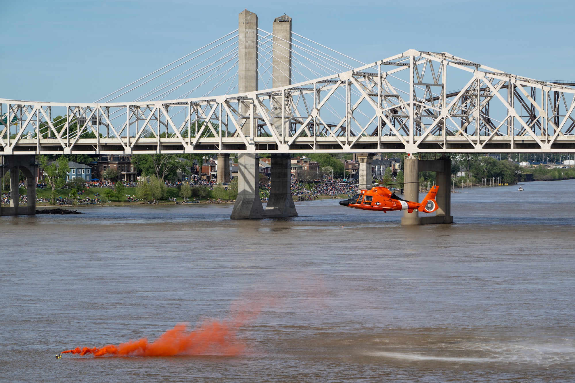 A U.S. Coast Guard rescue swimmer mark his location in the Ohio River as part of a helocast water-rescue demonstration during the Thunder Over Louisville air show in Louisville, Ky., April 20, 2024. This year’s event featured more than two-dozen military and civilian aircraft, including the Kentucky Air National Guard’s C130J Super Hercules. (U.S. Air National Guard photo by Dale Greer)