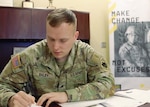 Sgt. McCale Biley, the Oklahoma National Guard's top recruiter for 2023, fills out paperwork in his office.