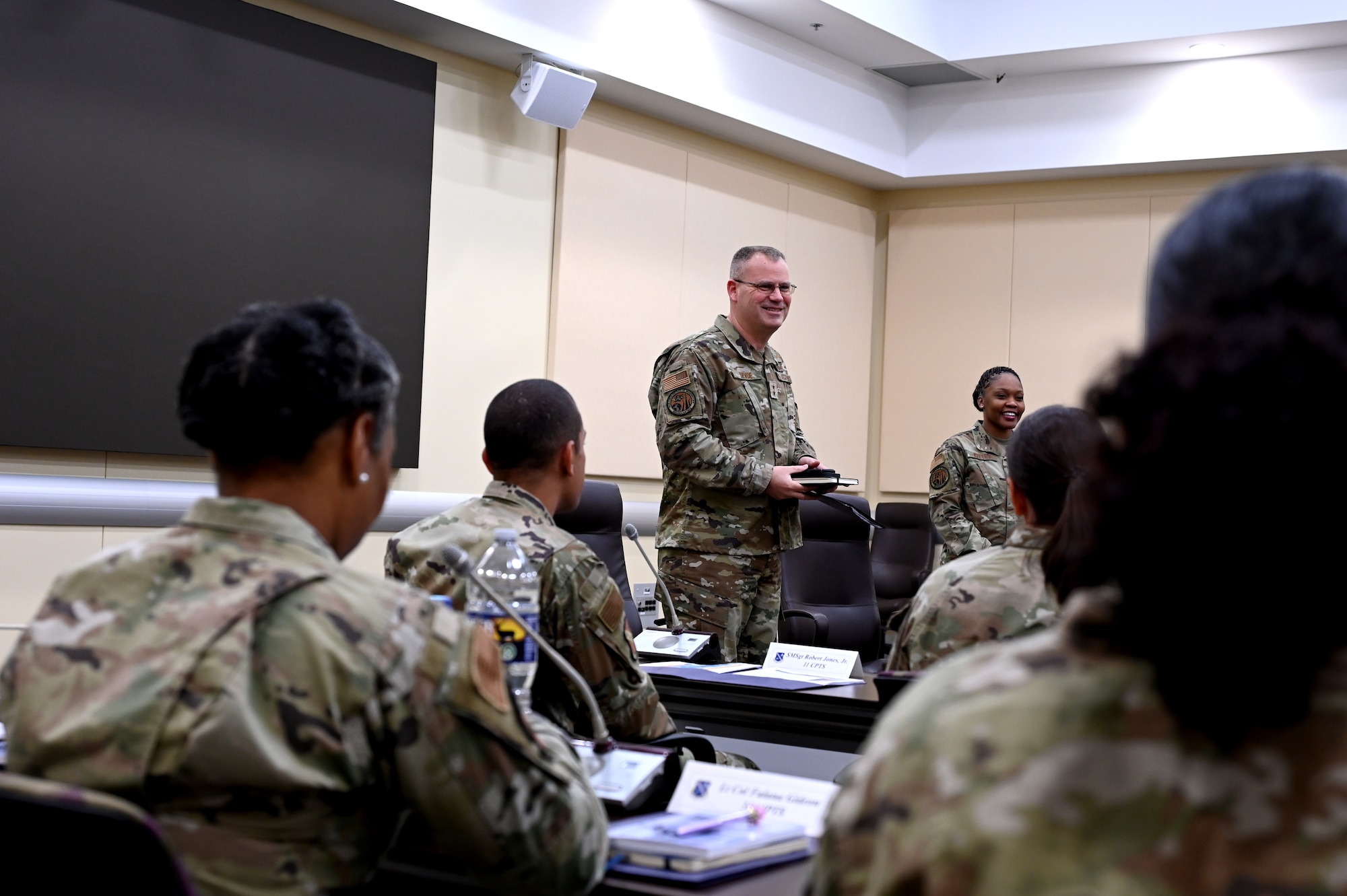 Maj. Gen. Daniel A. DeVoe, commander of the Air Force District of Washington, and Command Chief Master Sgt. Charmaine Kelley, greet the students of the Squadron Leadership Course, April 15, 2024, at the Jacob Smart Conference Center on Joint Base Andrews, Maryland.
