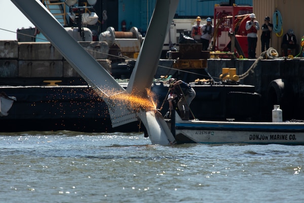 Key Bridge Response 2024 Unified Command salvors work to move a large piece of supporting steel from the collapsed Francis Scott Key Bridge, April 14, 2024, in Baltimore, Maryland. Removing these large pieces will help open a Limited Access Channel that allows one-way ship traffic to the Port of Baltimore.

Debris and wreckage removal is on-going in support of a top priority to safely and efficiently open the Fort McHenry channel