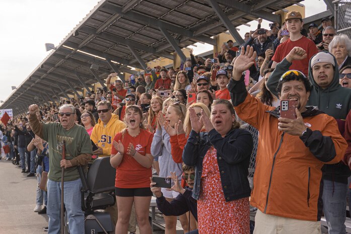 Friends and families with Alpha Company, 1st Recruit Training Battalion, cheer on their new Marines during a motivational run at Marine Corps Recruit Depot San Diego, California, April 18, 2024. The motivational run is the final training event new Marines complete before graduating which consists of a three-mile run throughout the Depot. (U.S. Marine Corps photo by Lance Cpl. Alexandra M. Earl)