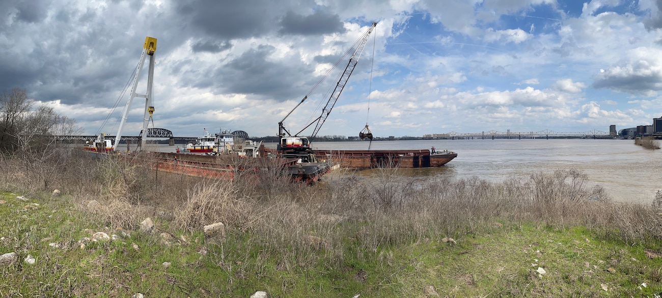 Crews work to offload coal from a partially submerged barge near the tip of Shippingport Island, in Louisville, Kentucky, March 14. It was one of 10 barges that broke away from a tow on the  Ohio River March 8.
