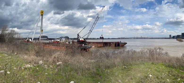 Crews work to offload coal from a partially submerged barge near the tip of Shippingport Island, in Louisville, Kentucky, March 14. It was one of 10 barges that broke away from a tow on the  Ohio River March 8.