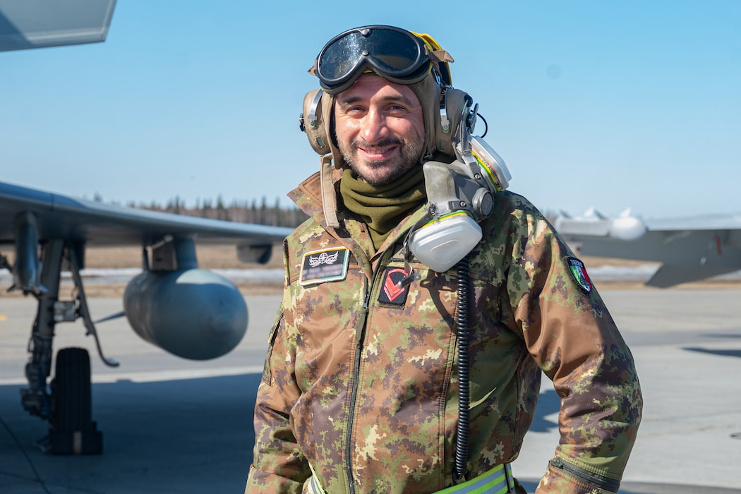 An Italian Air Force service member poses for a photo during Red Flag-Alaska 24-1. (This photo has been altered due to partner country privacy concerns by blurring out identification badges.)
