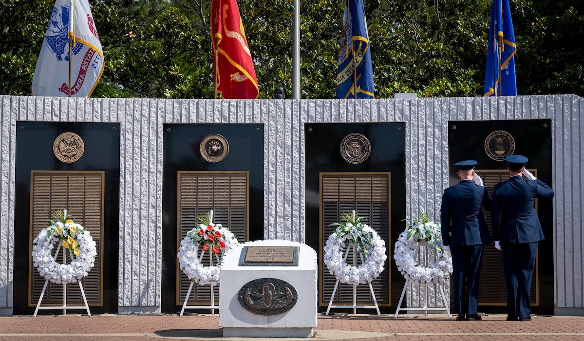 U.S. Air Force Chief Master Sgt. Michael Pasley and Lt. Col. Jeff Ledoux salute the list of lost Air Force explosive ordnance disposal technicians during the 54th Annual EOD Memorial Ceremony, May 6, 2023.