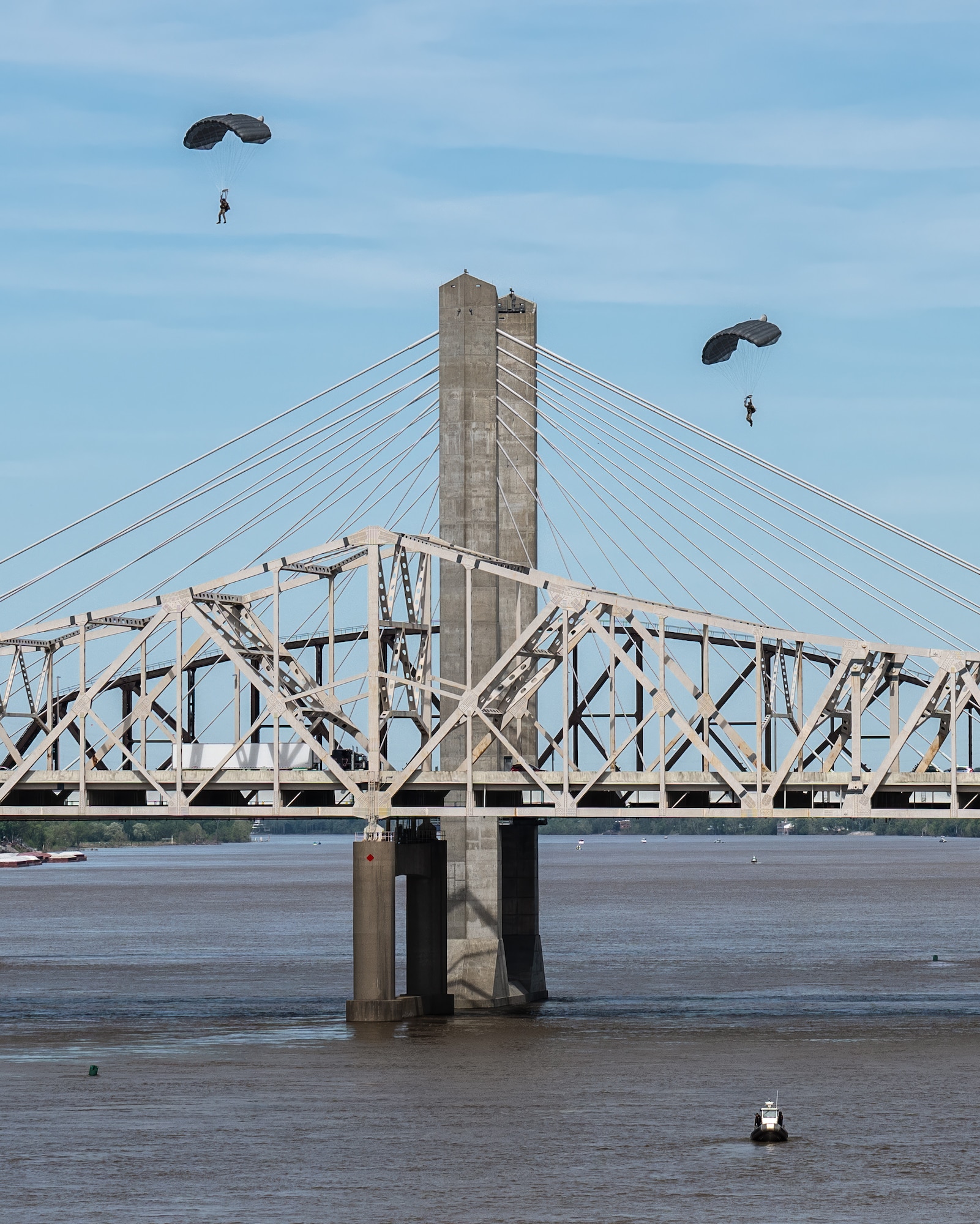 Two pararescuemen from the Kentucky Air National Guard’s 123rd Special Tactics Squadron parachute into the Ohio River as part of a demonstration during the Thunder Over Louisville air show in Louisville, Ky., April 20, 2024. This year’s event featured more than two-dozen military and civilian planes, including the Kentucky Air National Guard’s C130J Super Hercules. (U.S. Air National Guard photo by Dale Greer)