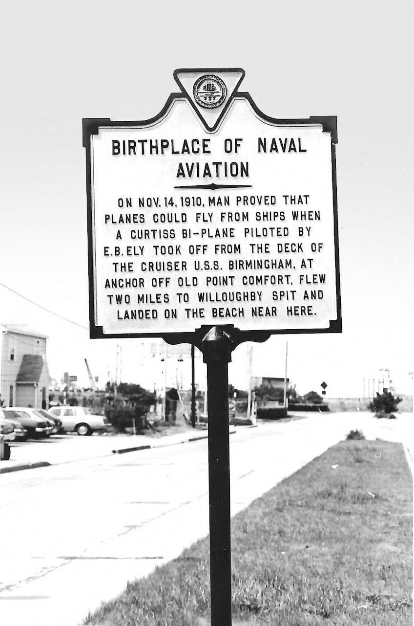 A commemorative sign on Virginia State Rt 60 Eastbound outside NAS Norfolk, just before the Hampton Roads Tunnel describes Ely’s flight from the scout cruiser USS Birmingham (CV-2) on November 14, 1910.