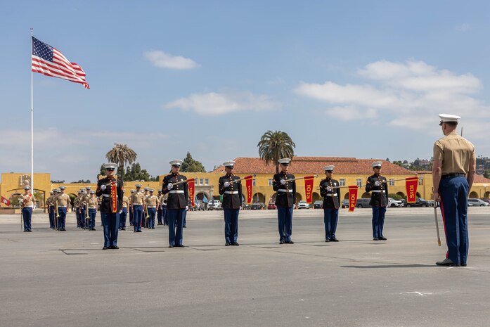 U.S. Marines with Alpha Company, 1st Recruit Training Battalion, present the guidons during a graduation ceremony at Marine Corps Recruit Depot San Diego, California, April 19, 2024. Graduation took place at the completion of the 13-week transformation, which included training for drill, marksmanship, basic combat skills, and Marine Corps customs and traditions. (U.S. Marine Corps photo by Cpl. Sarah M. Grawcock)