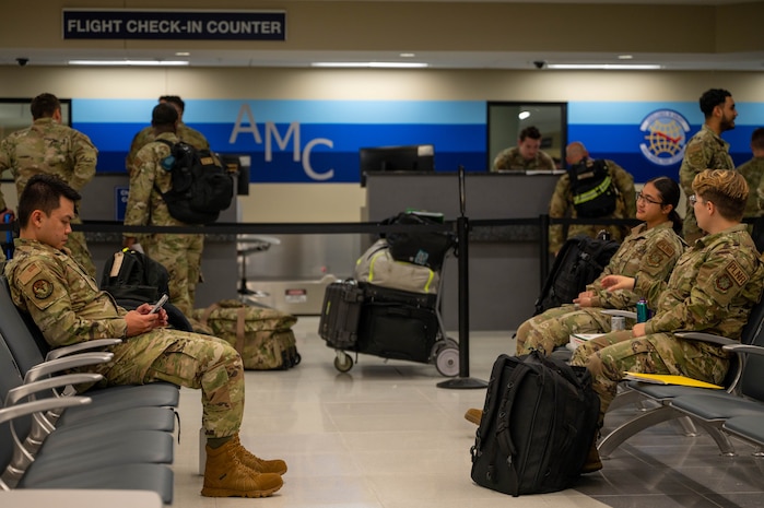 A photo of Airmen waiting in a terminal.