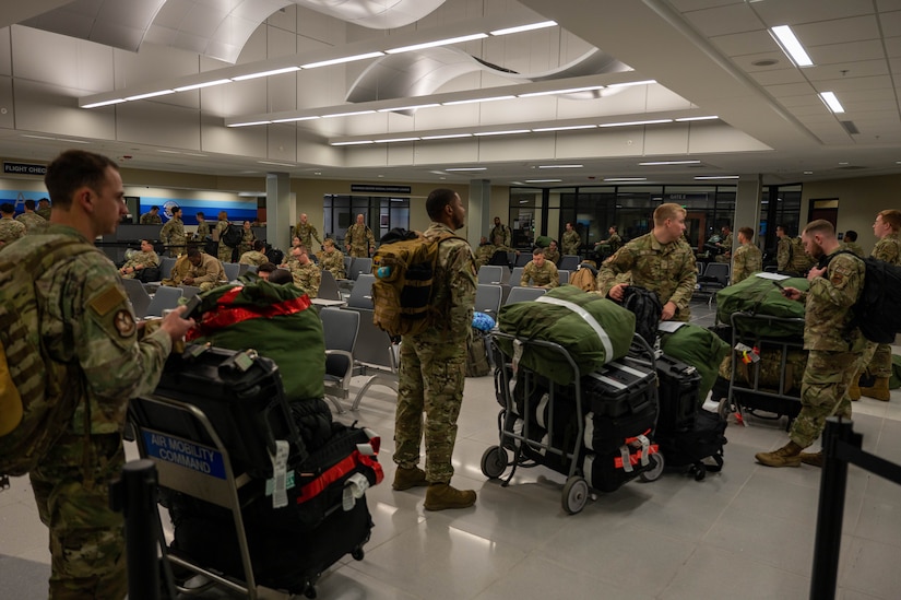 A photo of Airmen waiting in a terminal.