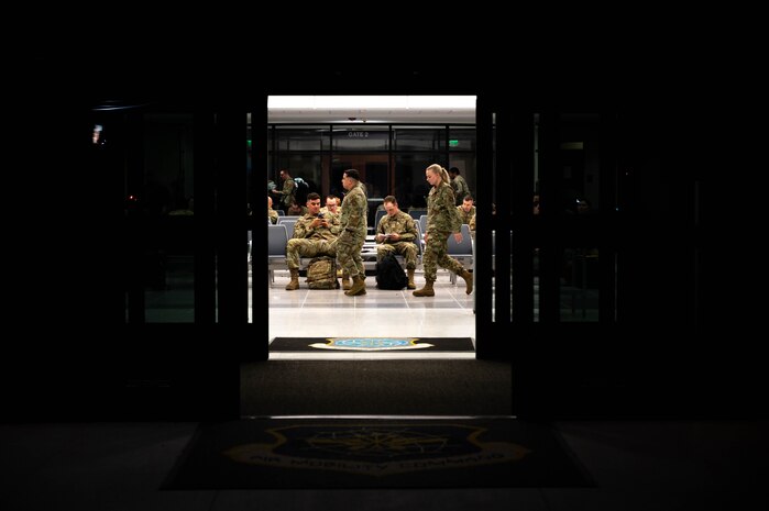 A photo of Airmen waiting in a terminal.