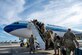 A photo of Airmen boarding a plane.