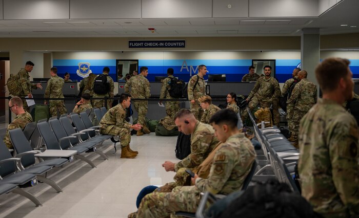 A photo of Airman waiting in a terminal.
