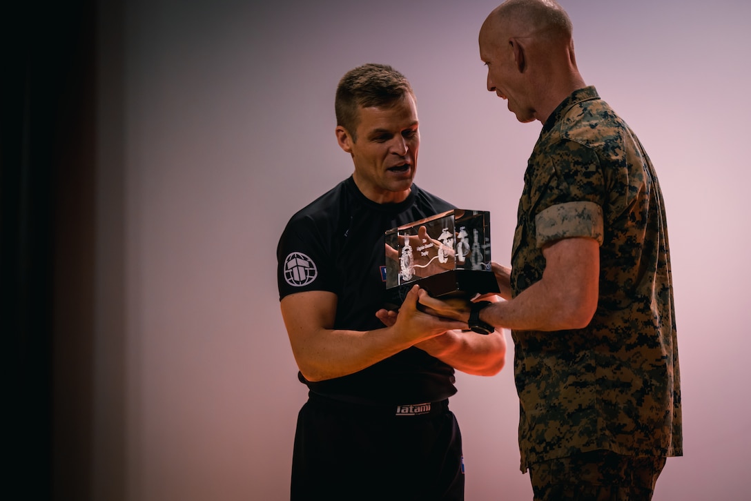 A Royal Marine receives the Virginia Gauntlet trophy from U.S. Marine Corps Lt. Gen. James Glynn, the deputy commandant for Manpower and Reserve Affairs, right, during the 2024 Virginia Gauntlet awards ceremony held on Marine Corps Base Quantico, Virginia, April 19, 2024. The Virginia Gauntlet challenges Royal Marines and U.S. Marines’ skills and abilities in a series of competitive events throughout multiple bases, with the Royal Marines being this year's victors. (U.S. Marine Corps photo by Lance Cpl. Joaquin Dela Torre)