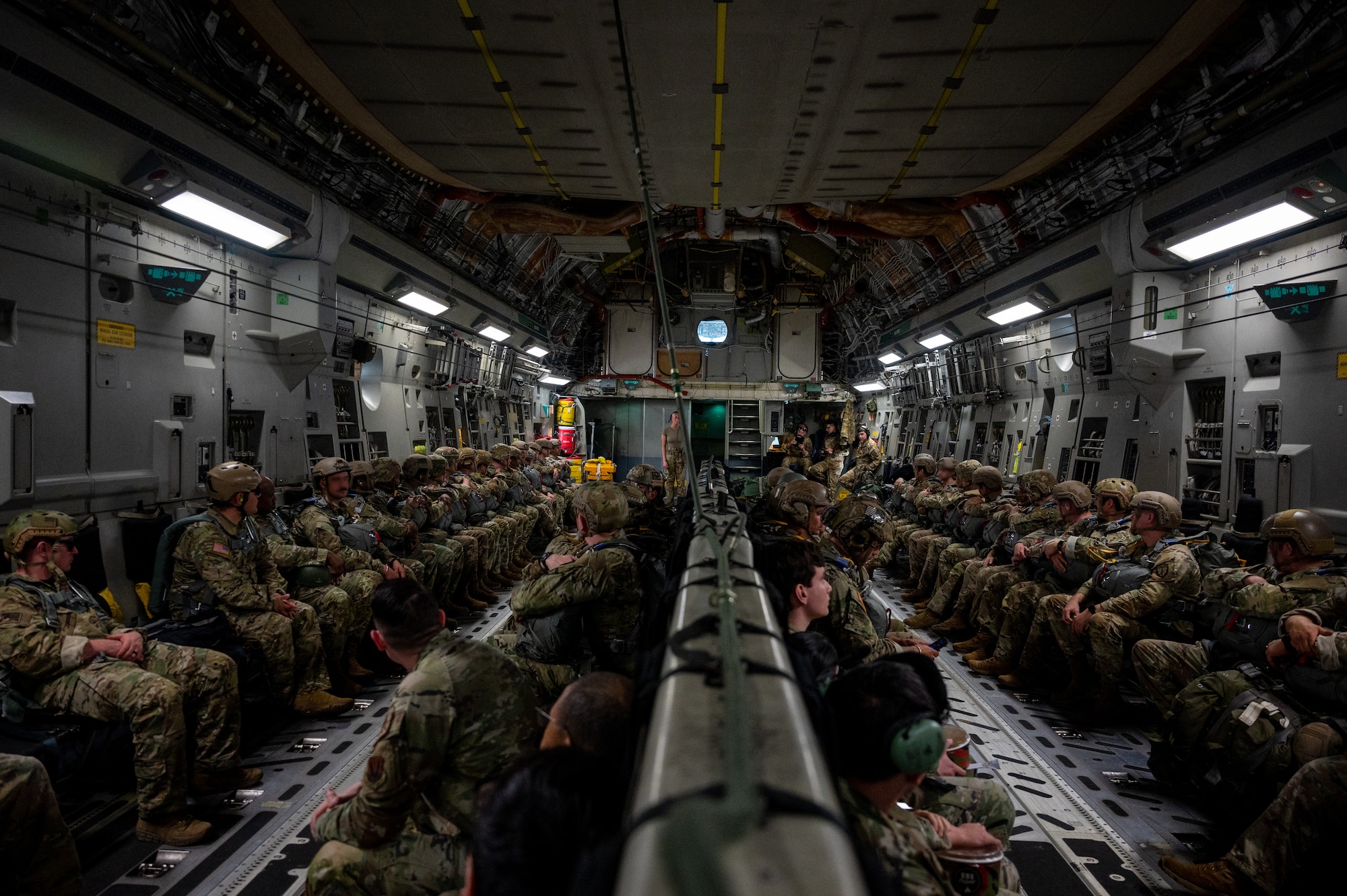 U.S. Special Operations Command Korea personnel sit inside a U.S. Air Force C-17 Globemaster III before airborne jump training during Korea Flight Training 24 at Osan Air Base, Republic of Korea, April 18, 2024. KFT 24 is a routine training designed to prepare combined forces for the deterrence of any potential threats through simulated combat scenarios. The U.S.-ROK. alliance is strengthened through integrated training, upholding commitments to maintain peace in Northeast Asia. (U.S. Air Force photo by Airman 1st Class Chase Verzaal) (This photo has been altered for security purposes.)