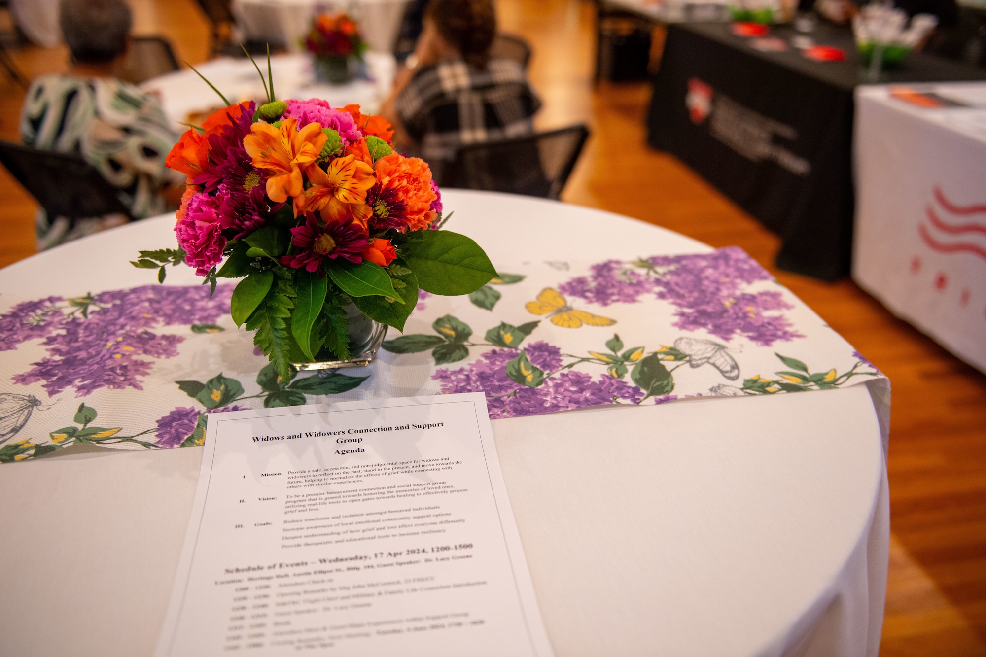 A bouquet  sits on a table decorated by the 23rd Force Support Squadron Military and Family Readiness Center for the Widows and Widowers Connection & Support Group event at Moody Air Force Base, Georgia, April 17, 2024. Widows and Widowers allow families from Lowndes County who have lost loved ones in and outside the military to get the support that they desire. (U.S. Air Force photo by 2nd Lt. Benjamin Williams)