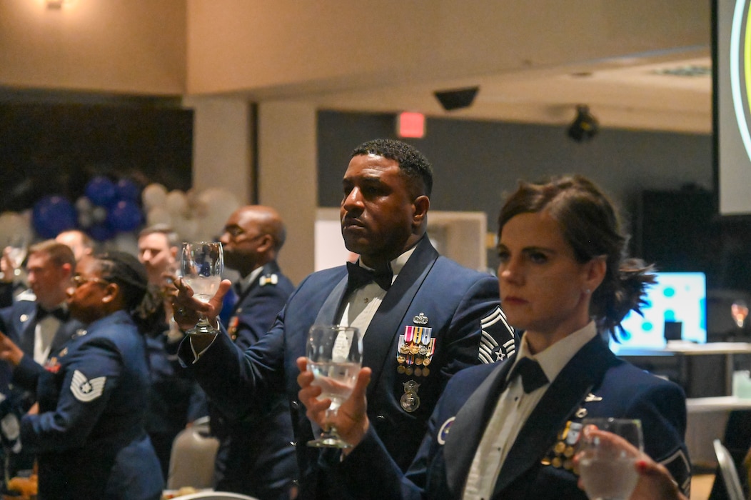 U.S. Air Force Senior Master Sgt. Jarmaine Thomas, 17th Security Forces Squadron operations superintendent, and Master Sgt. Jessica Abad, 316th Training Squadron instructor, raise a toast as part of the 2024 Chief Recognition Ceremony at the Powell Event Center, Goodfellow Air Force Base, Texas April 19, 2024. The rank of a chief master sergeant in the Air Force is to serve in the highest enlisted grade and hold strategic leadership positions with tremendous influence in the Air Force. (U.S. Air Force photo by Airman James Salellas)