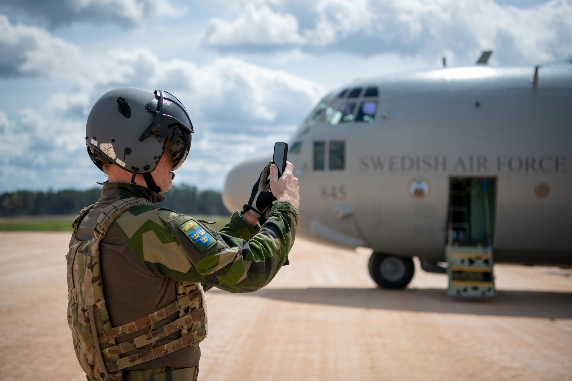 An Airman with the Swedish Air Force takes a photo during Exercise STORM FLAG at Alexandria International Airfield, Louisiana, March 12, 2024.