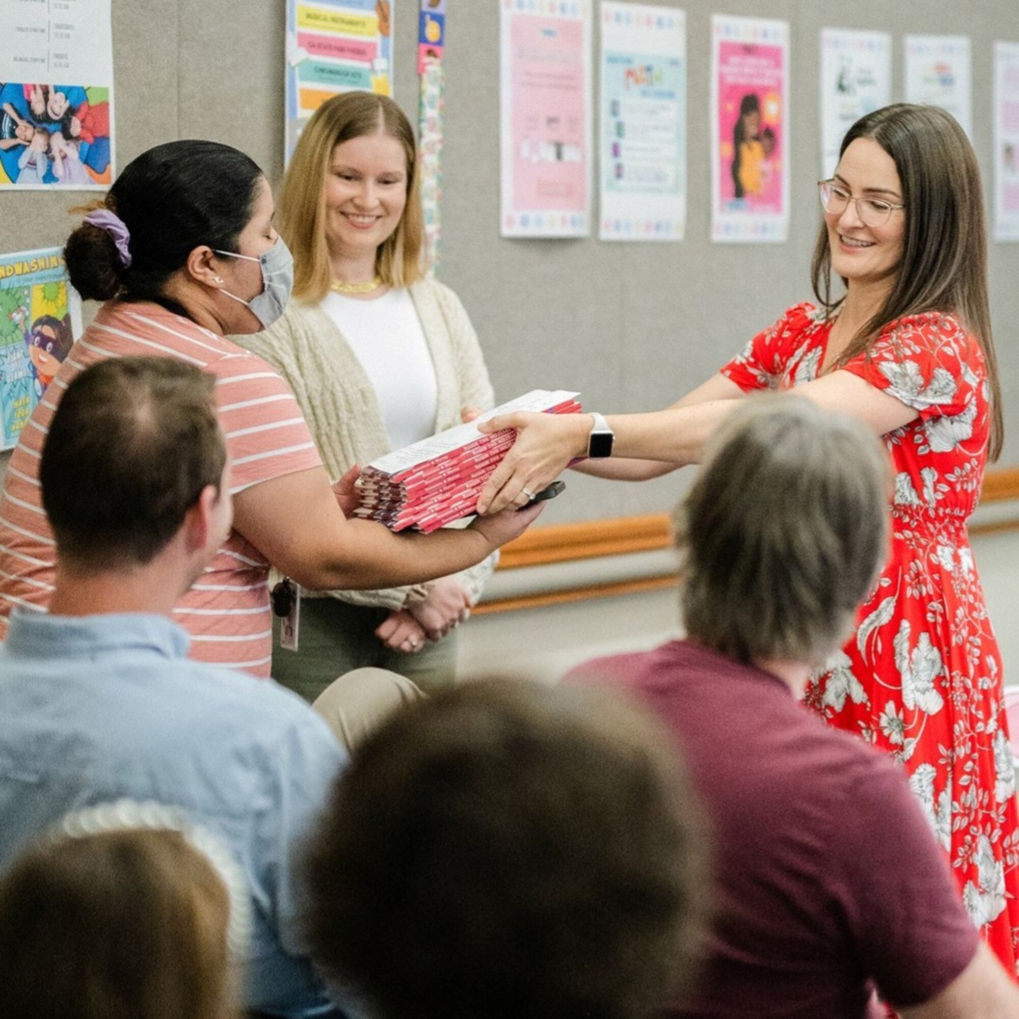 Woman hands books over.