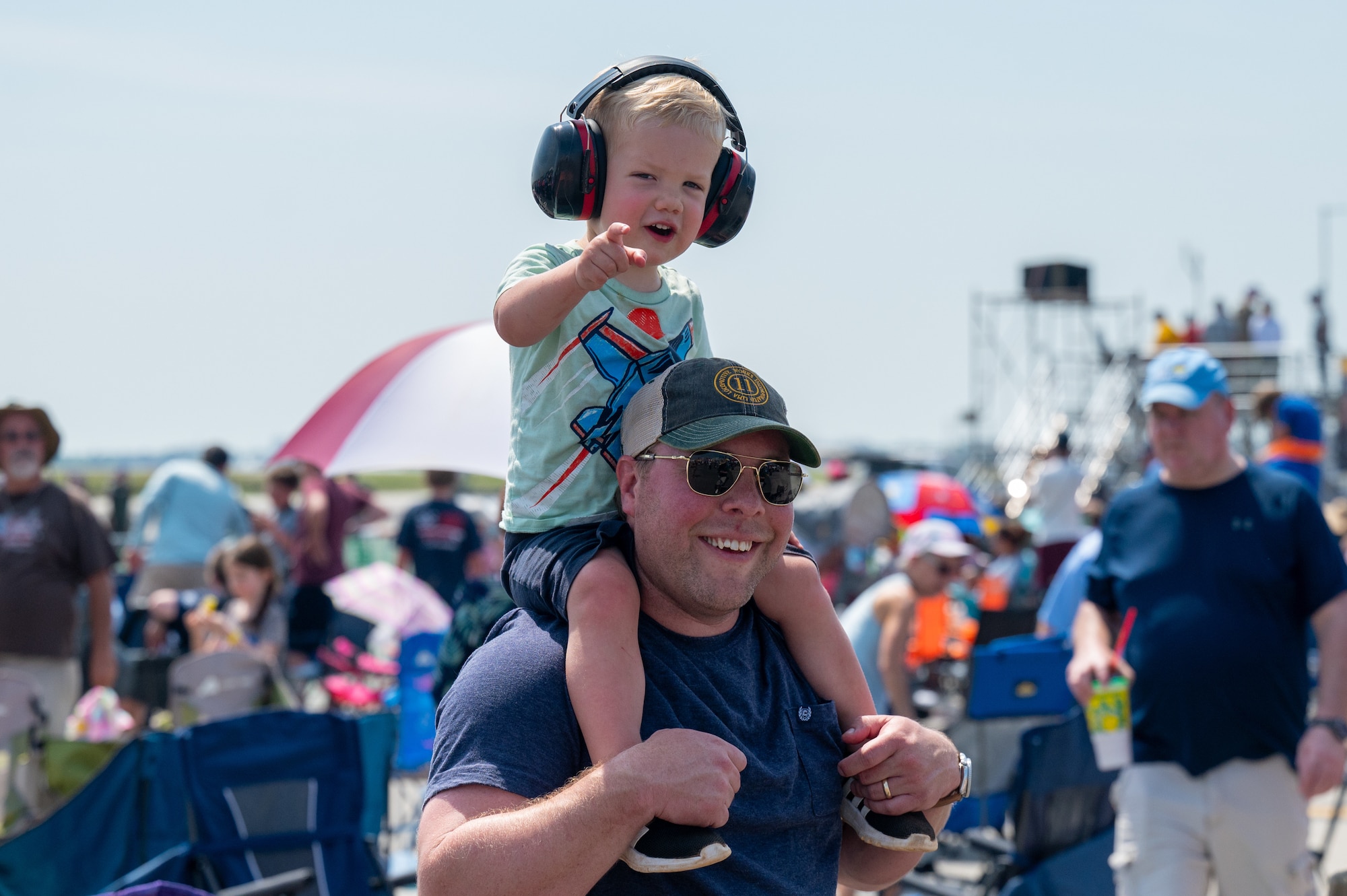 A kid and a dad smile for a photo.