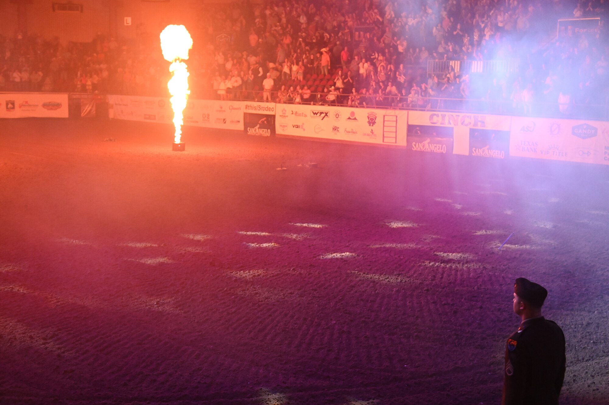 U.S. Army Staff Sgt. Daniel Moody stands at the position of attention representing the Army during the service branch spotlight portion of the Military Appreciation Night of the San Angelo Stock Show and Rodeo at Foster Communications Coliseum, San Angelo, Texas, April 17, 2024. People in attendance stood and cheered as every branch on Goodfellow was announced as part of the spotlight. (U.S. Air Force photo by Airman James Salellas)