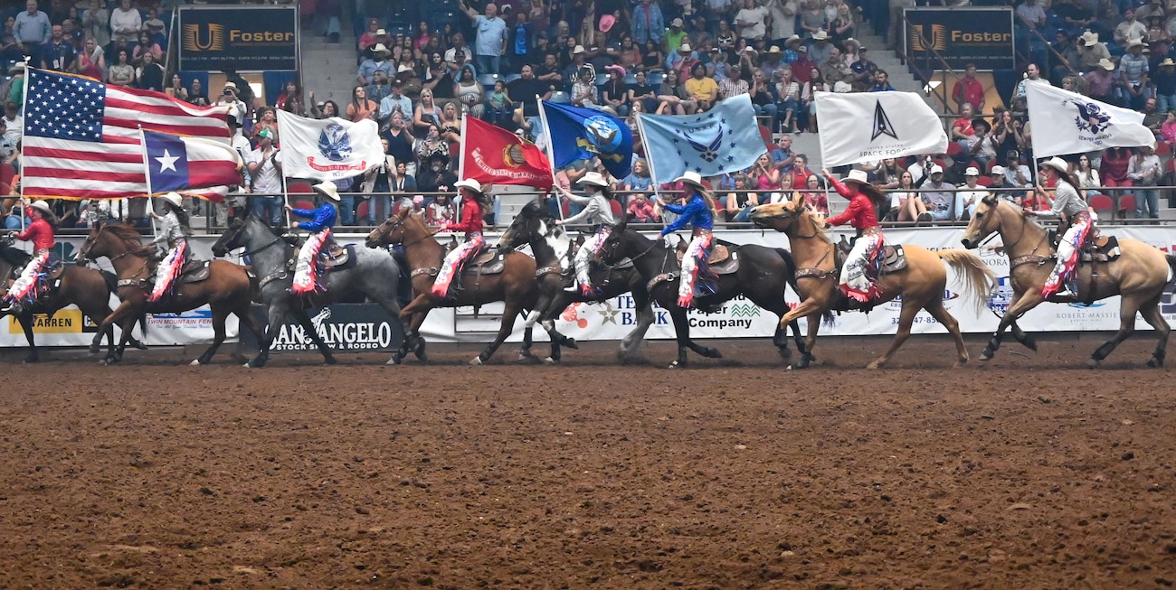 San Angelo Stock Show and Rodeo Ambassadors carry the U.S., Texas, and U.S. military service branch flags at the San Angelo Stock Show & Rodeo at Foster Communications Coliseum in San Angelo, Texas, April 17, 2024. The Ambassadors carried the flags at the beginning of Military Appreciation Night. (U.S. Air Force photo by Airman 1st Class Brian Lummus)