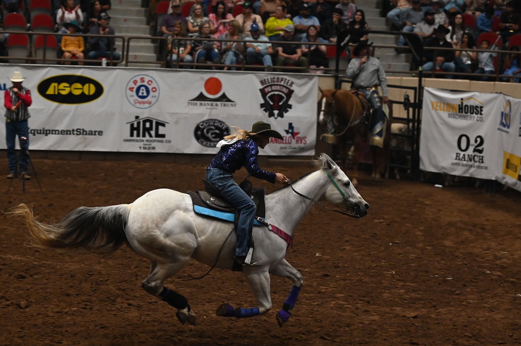 Tiany Schuster, a barrel racer from Krum, Texas, competes during the San Angelo Stock Show & Rodeo at the Foster Communications Coliseum in San Angelo, Texas, April 17, 2024. Schuster ranked 2nd place on the leaderboard with a time of 14.05 seconds on Military Appreciation Night. (U.S. Air Force photo by Airman 1st Class Brian Lummus)