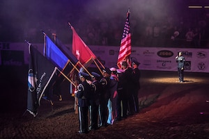 U.S. Air Force Tech. Sgt. Breanna Boykin, 316th Training Squadron instructor, sings The Star-Spangled Banner at the Foster Communications Coliseum, San Angelo, Texas, April 17, 2024. Boykin sang the national anthem to kick off the annual military appreciation night hosted by the San Angelo Stock Show & Rodeo Association. (U.S. Air Force photo by Airman James Salellas)