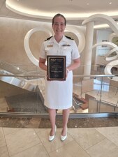 U.S. Navy Lt. (Dr.)Kathryn Flynn is all smiles after receiving a Profile in Excellence Award presented by the Maryland Chapter of the American College of Physicians on January 28, 2023, in Ellicott City, Maryland. Photo Credit: U.S. Army Cpt. (Dr.) Brendan Flynn.