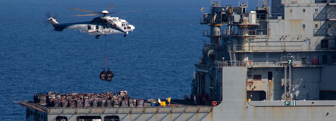 240420-N-EQ851-1089 SOUTH CHINA SEA (April 20, 2024) An AS-332 Super Puma, assigned to the Lewis and Clark-class dry cargo ship USNS Wally Schirra (T-AKE 8), delivers supplies during a vertical replenishment aboard the Nimitz-class aircraft carrier USS Theodore Roosevelt (CVN 71), April 20, 2024. Theodore Roosevelt, flagship of Carrier Strike Group Nine, is underway conducting routine operations in the U.S. 7th Fleet area of operations. U.S. 7th Fleet is the U.S. Navy’s largest forward-deployed numbered fleet, and routinely interacts and operates with allies and partners in preserving a free and open Indo-Pacific region. (U.S. Navy photo by Mass Communication Specialist 3rd Class Adina Phebus)