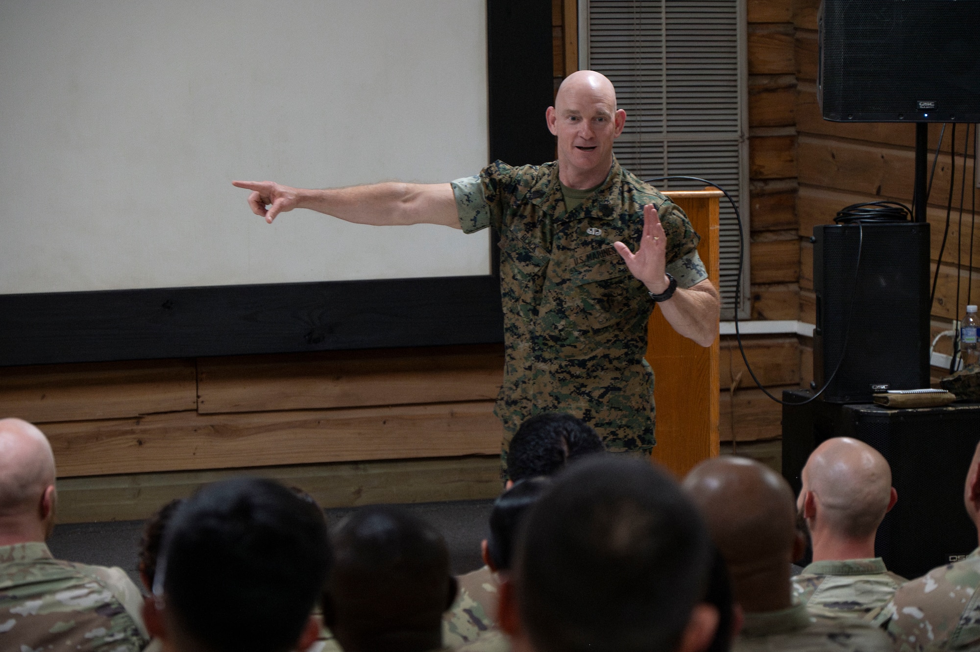 A photo of a service member talking to a crowd.