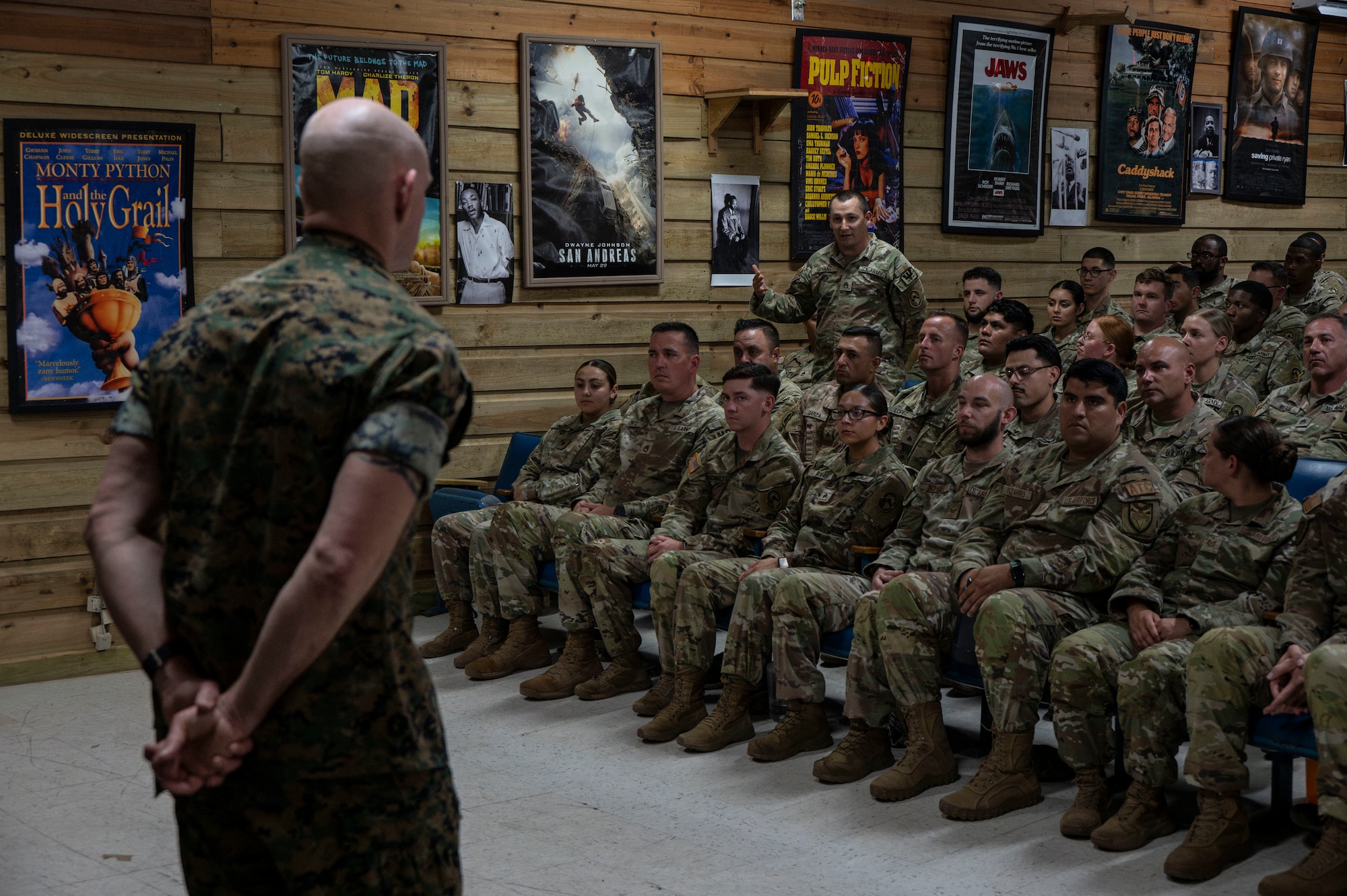 A photo of a service member talking to a crowd.