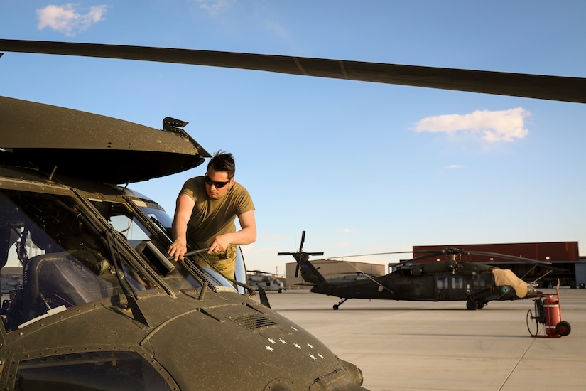 Alaska Army National Guard Sgt. Caelan Guthrie, assigned to the 207th Aviation Troop Command, performs post-flight maintenance on their UH-60L Black Hawk helicopter during the Weapons and Tactics Instructor Course 2-24 at Marine Corps Air Station Yuma, Ariz., April 8, 2024.