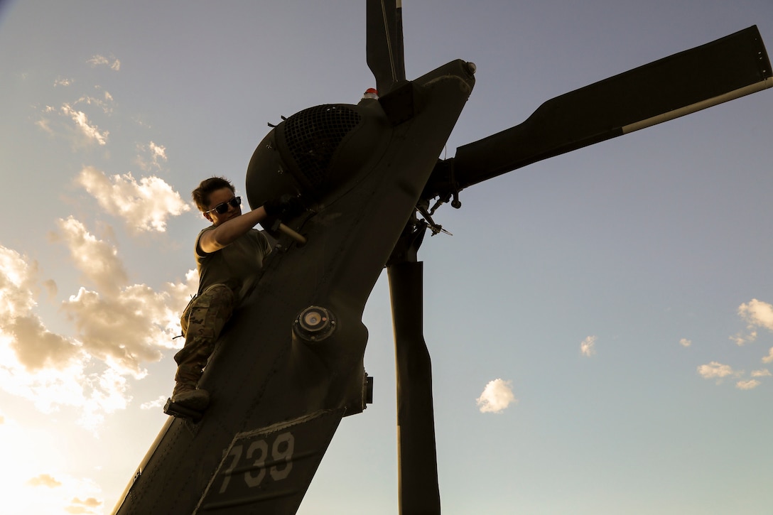 Alaska Army National Guard Spc. Hannah Kinder, a UH-60 Black Hawk helicopter mechanic assigned to the 207th Aviation Troop Command, performs post-flight maintenance on a UH-60L Black Hawk helicopter during the Weapons and Tactics Instructor Course 2-24 at Marine Corps Air Station Yuma, Ariz., April 8, 2024.