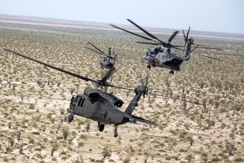 An Alaska Army National Guard UH-60L Black Hawk helicopter assigned to the 207th Aviation Troop Command, and two U.S. Marine Corps CH-53E Super Stallion helicopters from Marine Aviation Weapons and Tactics Squadron One perform defensive maneuvers in response to simulated ground threats during the Weapons and Tactics Instructor Course 2-24 near Marine Corps Air Station Yuma, Ariz., March 26, 2024.