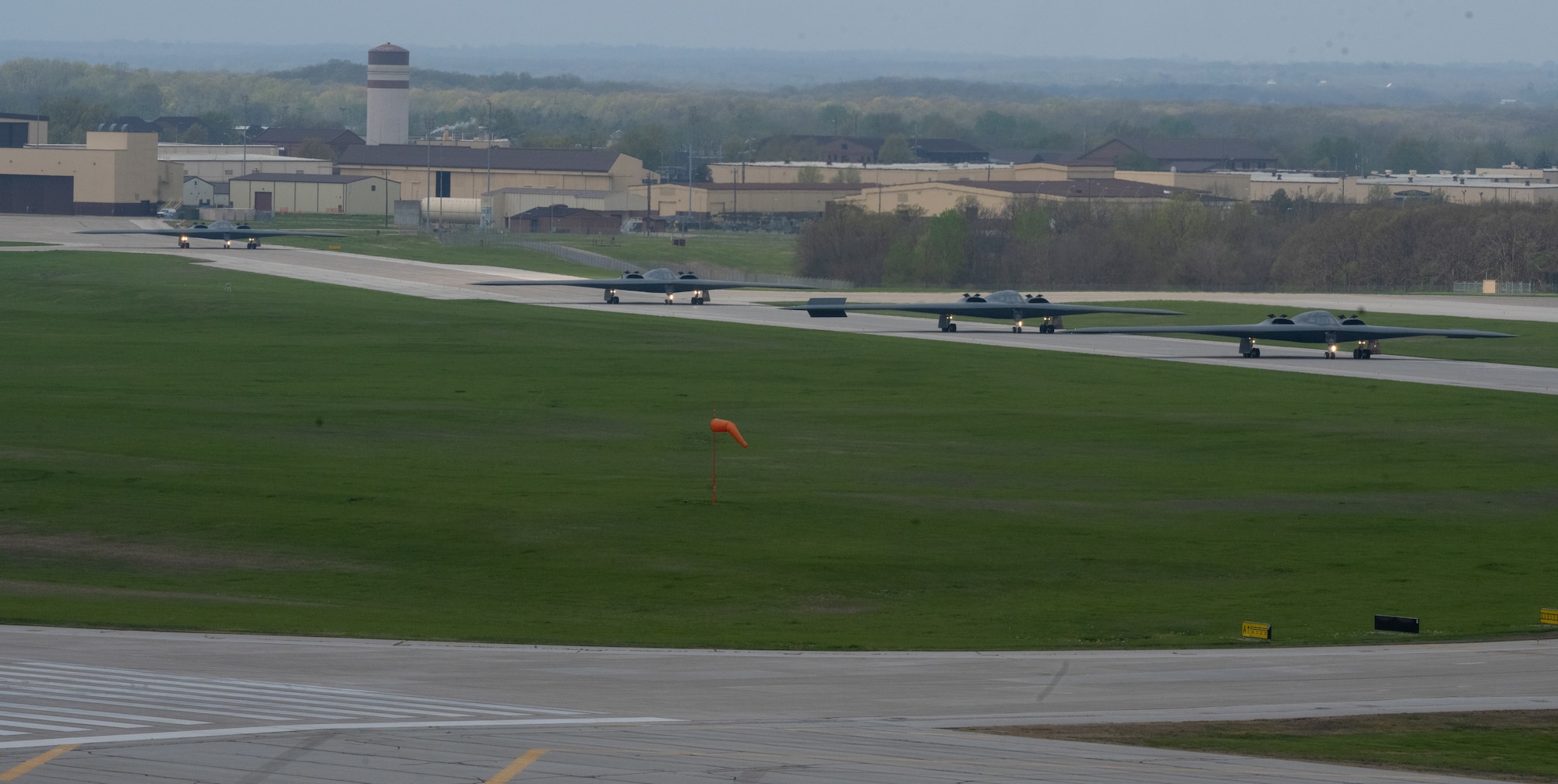 B-2 Spirit stealth bombers assigned to the 509th Bomb Wing taxi on the runway at Whiteman Air Force Base, Mo., April 15, 2024. Team Whiteman executed a mass fly-off of 12 B-2s to cap off the annual Spirit Vigilance exercise.