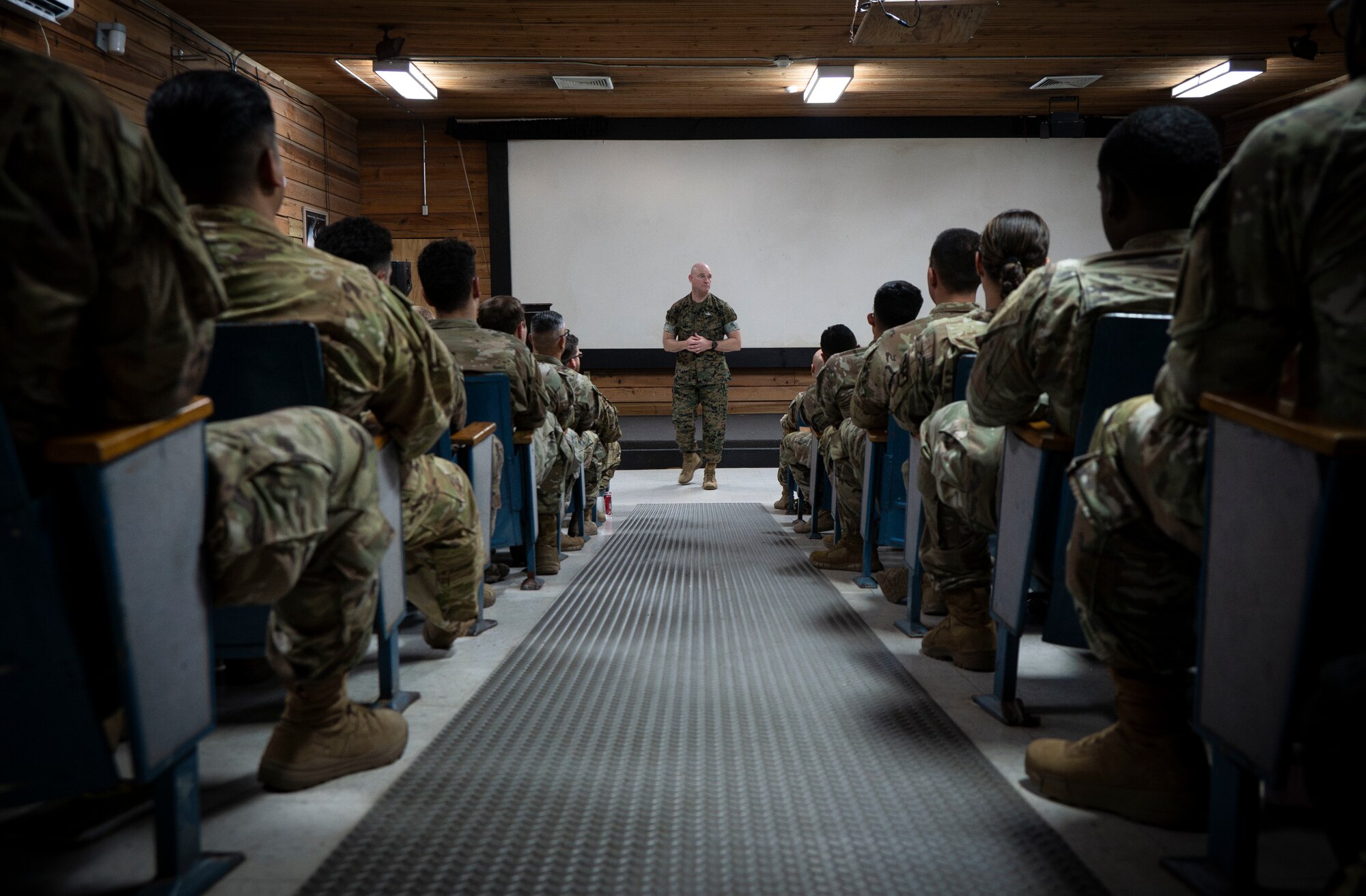 A photo of a service member talking to a crowd.