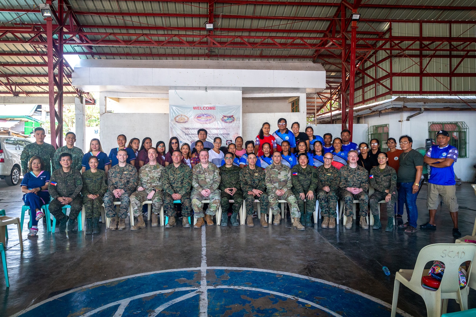 Philippine and U.S. service members with the Combined Joint Civil-Military Operations Task Force pose for a photograph with local healthcare workers and Ilocos Norte residents after a community health engagement held before Exercise Balikatan 24 at Davila Elementary School in Pasuquin, Ilocos Norte, Philippines, April 21, 2024. The Philippine and U.S. service members trained Ilocos Norte healthcare workers and residents on basic lifesaving skills such as cardiopulmonary resuscitation and tactical combat casualty care, increasing emergency care access and awareness. BK 24 is an annual exercise between the Armed Forces of the Philippines and the U.S. military designed to strengthen bilateral interoperability, capabilities, trust, and cooperation built over decades of shared experiences. (U.S. Marine Corps photo by Cpl. Trent A. Henry)