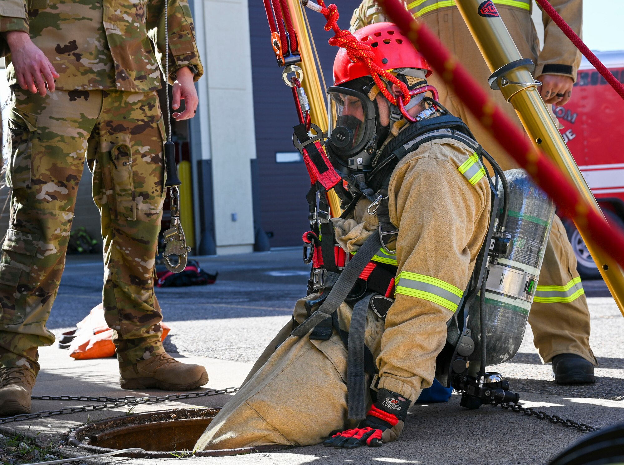 A man sliding into a manhole