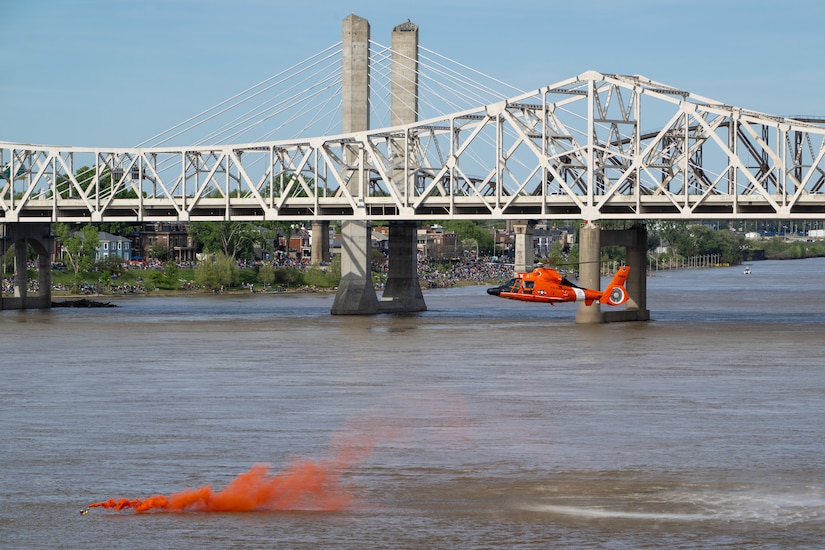 A U.S. Coast Guard rescue swimmer mark his location in the Ohio River as part of a helocast water-rescue demonstration during the Thunder Over Louisville air show in Louisville, Ky., April 20, 2024. This year’s event featured more than two-dozen military and civilian aircraft, including the Kentucky Air National Guard’s C130J Super Hercules. (U.S. Air National Guard photo by Dale Greer)