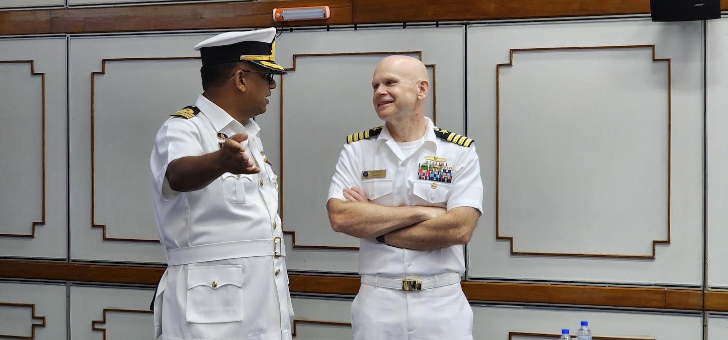 240422-N-NR876-1434 CHATTOGRAM, Bangladesh (April 22, 2024)- Capt. Matthew Scarlett, right, deputy commodore, Destroyer Squadron (DESRON) 7 speaks with Rear Adm. Mohammad Anwar Hossain, left, Bangladesh Navy Assistant Chief of Naval Staff (Operations) during the opening ceremony for Cooperation Afloat Readiness and Training (CARAT) Exercise Bangladesh 2024.CARAT Bangladesh is a week-long exercise that seeks to enhance collaboration focused on shared maritime security challenges in the region. As the 30th iteration of the Cooperation Afloat Readiness and Training (CARAT) series, 2024 highlights the longstanding role of CARAT as a credible venue for regional Allies and partners to address shared maritime security priorities.