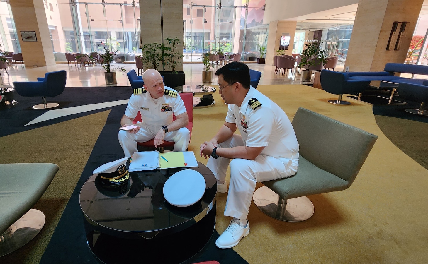240422-N-NR876-1522 CHATTOGRAM, Bangladesh (April 22, 2024)- Capt. Matthew Scarlett, left, Commander, Destroyer Squadron (DESRON) 7 deputy commodore discusses the schedule of events with Lt. Cmdr. Jun Chen, lead U.S. planner, prior to the opening ceremony for Cooperation Afloat Readiness and Training (CARAT) Exercise Bangladesh 2024 in Chattogram, Bangladesh, Apr. 22. As the 30th iteration of the Cooperation Afloat Readiness and Training (CARAT) series, 2024 highlights the longstanding role of CARAT as a credible venue for regional Allies and partners to address shared maritime security priorities. As the U.S. Navy’s destroyer squadron forward-deployed in Southeast Asia, DESRON 7 serves as the primary tactical and operational commander of littoral combat ships rotationally deployed to Singapore, Expeditionary Strike Group 7’s Sea Combat Commander and builds partnerships through training exercises and military-to-military engagements.(U.S. Navy photo by Chief Electronics Technician Nguyet Mai)