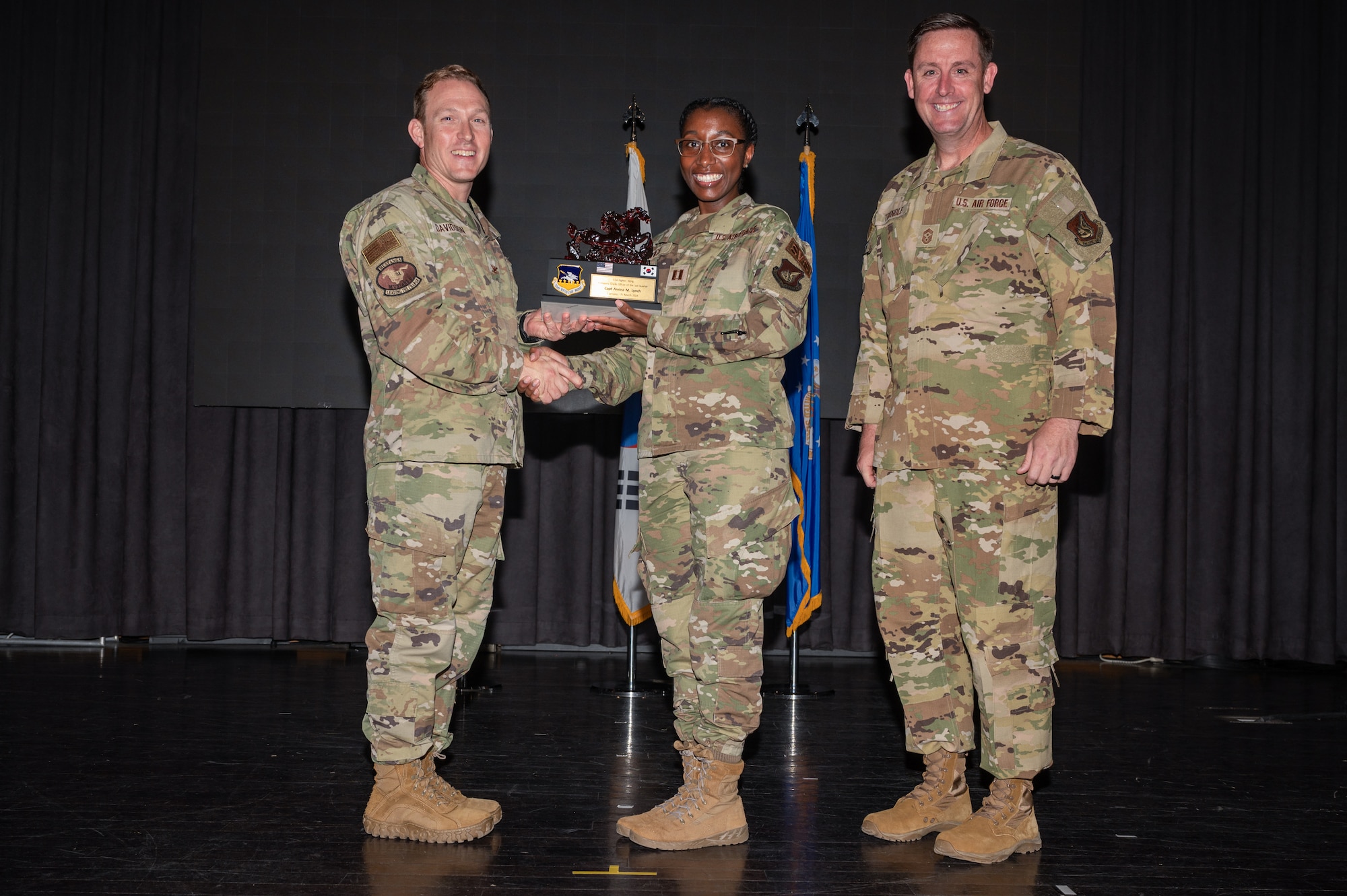 The 51st Fighter Wing command team presents the Company Grade Officer of the Quarter award to Capt. Amina Lynch, 51st Force Support Squadron sustainment services flight commander, during the 51st FW quarterly awards ceremony at Osan Air Base, Republic of Korea, April 19, 2024. 51st FW leadership regularly acknowledges outstanding performers, expressing appreciation for their contributions to the "Fight Tonight" mission. (U.S. Air Force photo by Airman 1st Class Chase Verzaal)