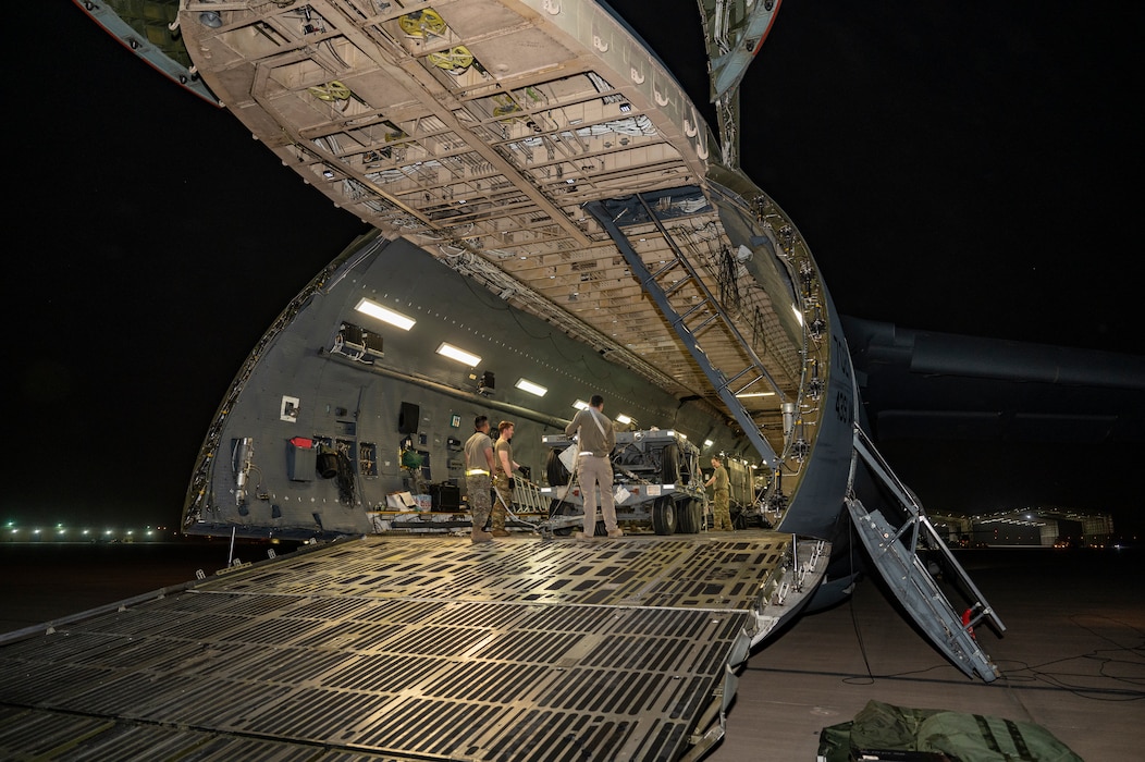 U.S. Air Force C-5 Galaxy loadmasters prepare to offload cargo at an undisclosed location, U.S. Central Command Area of Responsibility, April 22, 2024.  The U.S. Air Force is globally postured to protect and defend freedom of coalition allies and regional partners to maintain peace and stability across the region. (U.S. Air Force photo)