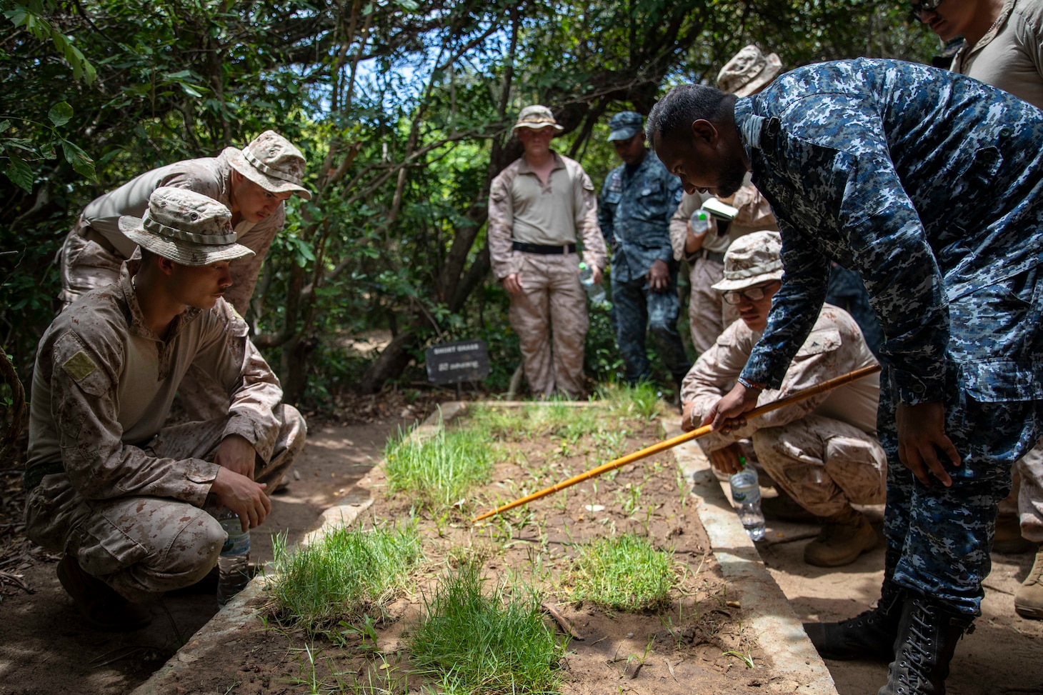A member of the Sri Lanka Navy (SLN) teaches U.S. Marines assigned to Fleet Anti-Terrorism Security Team Pacific tracking techniques in grassy areas as part of exercise Cooperation Afloat Readiness and Training (CARAT) Sri Lanka 2024 at SLNS Vidura, April 23. CARAT Sri Lanka is a bilateral exercise between Sri Lanka and the United States designed to promote regional security cooperation and strengthen maritime understanding, partnerships, and interoperability. In its 29th year, the CARAT series is comprised of multinational exercises, designed to enhance U.S. and partner forces’ abilities to operate together in response to traditional and non-traditional maritime security challenges in the Indo-Pacific region. (U.S. Navy photo by Mass Communication Specialist 1st Class Charles Oki)