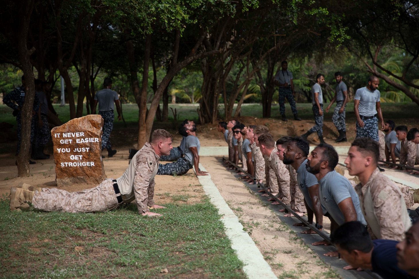 U.S. Marines assigned to Fleet Anti-Terrorism Security Team Pacific and members of the Sri Lanka Navy (SLN) take part in group physical training as part of exercise Cooperation Afloat Readiness and Training (CARAT) Sri Lanka 2024 at SLNS Vidura, April 23. CARAT Sri Lanka is a bilateral exercise between Sri Lanka and the United States designed to promote regional security cooperation and strengthen maritime understanding, partnerships, and interoperability. In its 29th year, the CARAT series is comprised of multinational exercises, designed to enhance U.S. and partner forces’ abilities to operate together in response to traditional and non-traditional maritime security challenges in the Indo-Pacific region. (U.S. Navy photo by Mass Communication Specialist 1st Class Charles Oki)