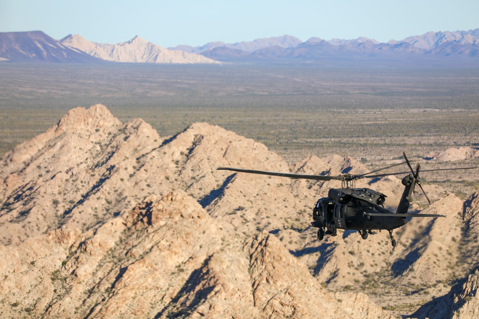 U.S. Army aviators, assigned to 207th Aviation Troop Command, transport troops via Alaska Army National Guard UH-60L Black Hawk helicopters during the Weapons and Tactics Instructor course 2-24 near Marine Corps Air Station Yuma, Ariz., April 3, 2024. During the seven-week course, two Army Black Hawk aircrews flew an intensive schedule of simulated combat missions with U.S., allied and opposing force fixed wing and rotary aircraft.