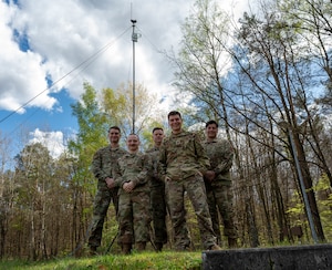 Members from the Project Arc team and the 1st Communications Maintenance Squadron pose for a group picture in front of an electromagnetic spectrum sensor at Kapaun Air Station, Germany, April 9, 2024. The Project Arc team was formed in July 2020 as a grassroots effort under AFWERX to forge ahead in the U.S. Air Force 2030 Science and Technology Strategy. Its goal is to provide operational units with a dedicated team of scientists and engineers who provide tailored, innovative tools for future conflicts. (U.S. Air Force photo by Senior Airman Jordan Lazaro)